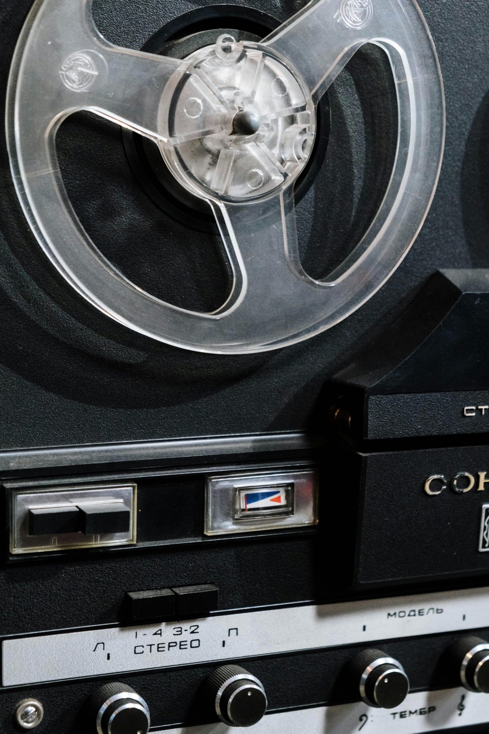 Close-up of a vintage reel-to-reel tape recorder showcasing classic analog technology.